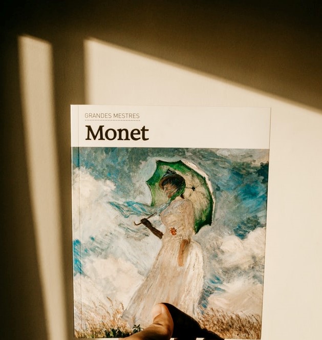 women in white dress painting by claude monet